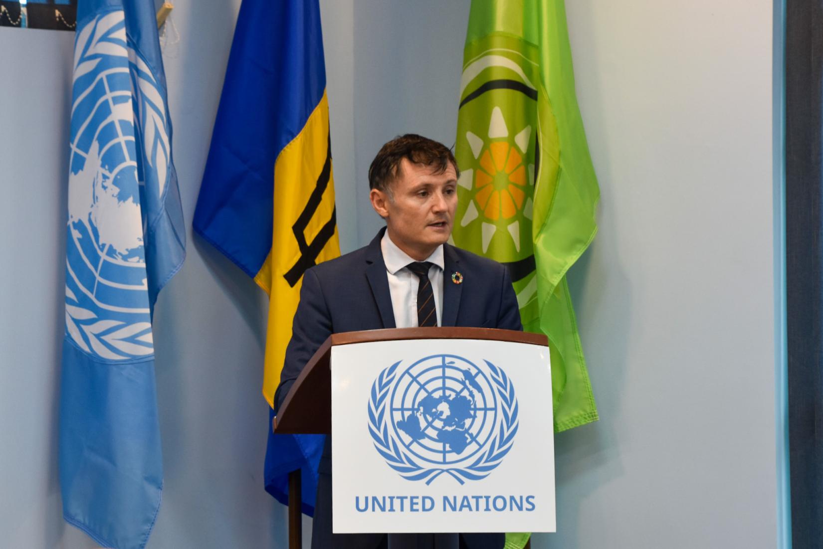 Standing at the podium delivering remarks, Resident Coordinator for Barbados and the Eastern Caribbean, Didier Trebucq. (File Photo)