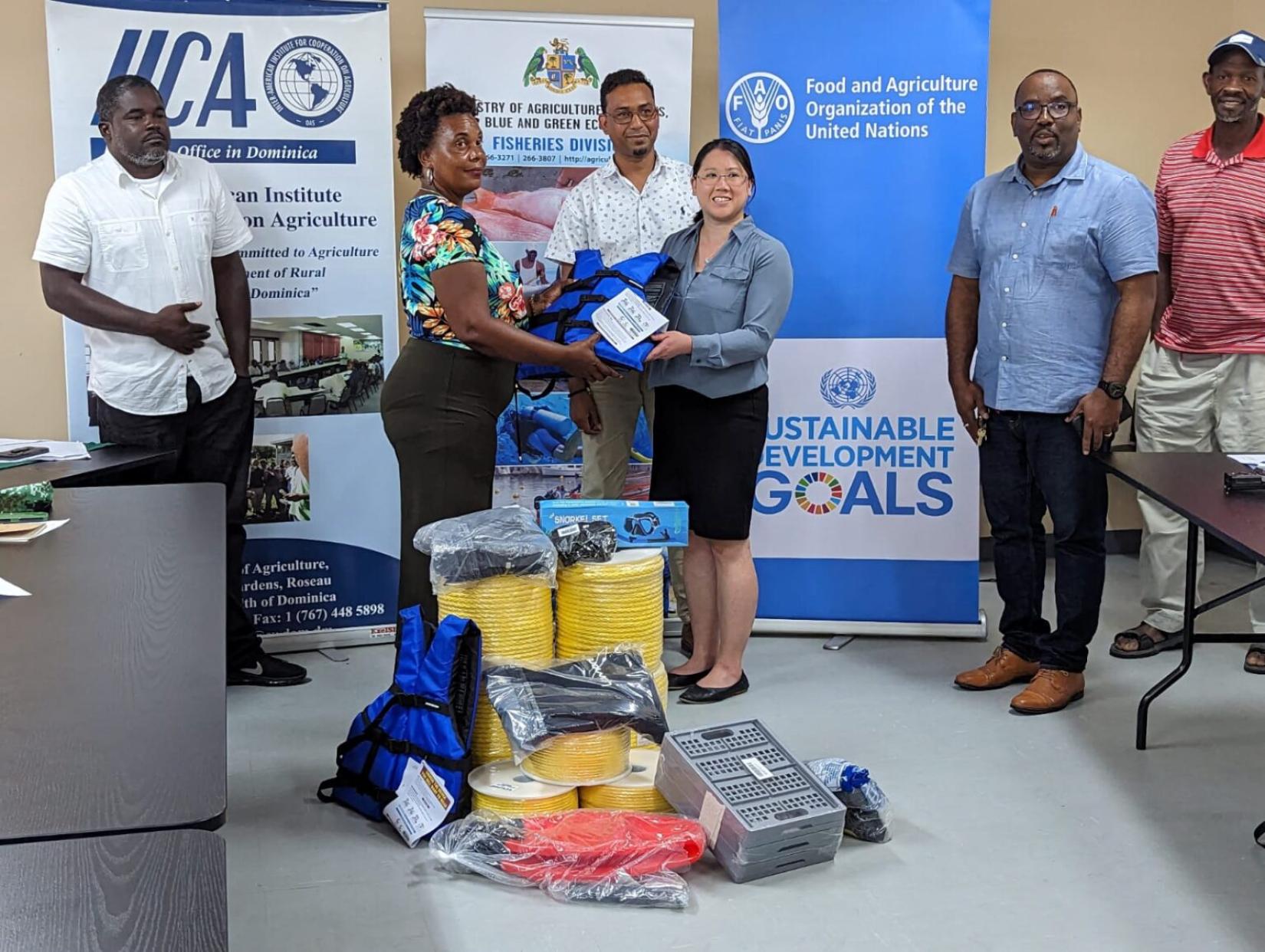 Two women stand for a photo op receiving and donating sea moss equipment