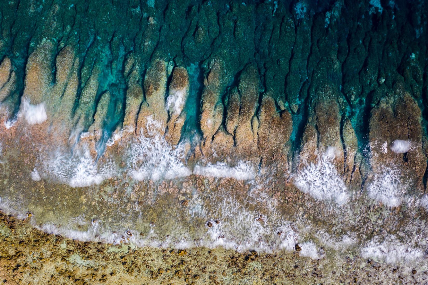 Waves from the Pacific Ocean crash onto Funafuti’s shoreline. 