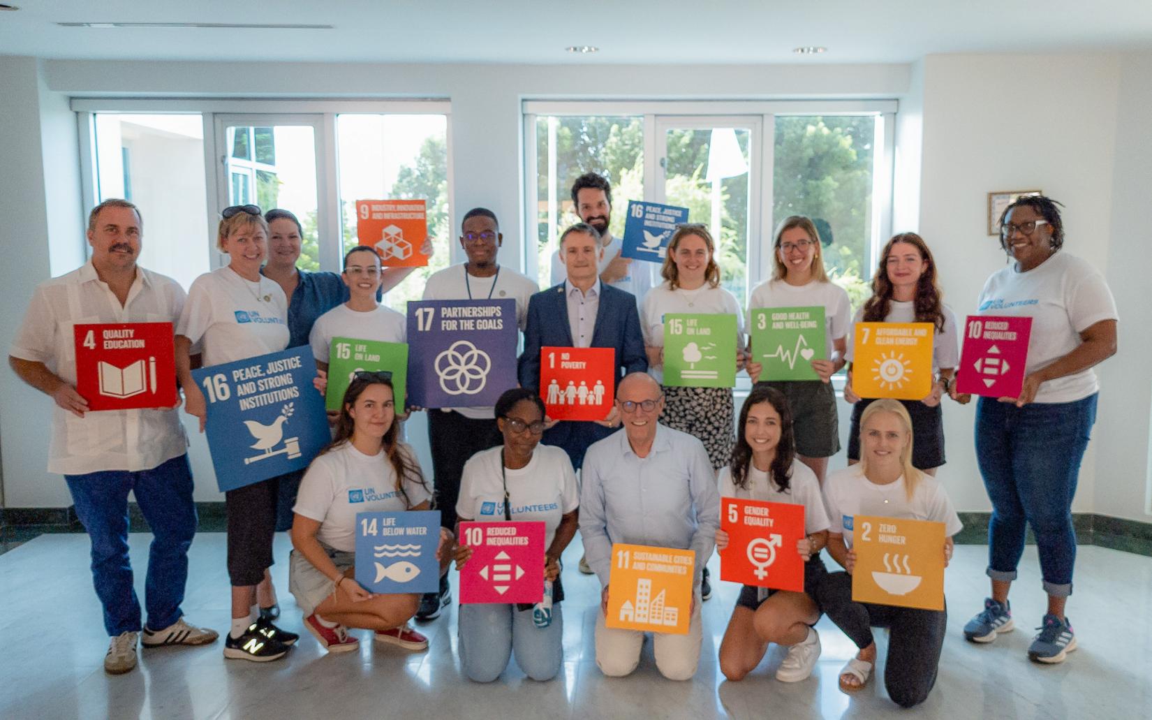 a group of people holding SDG cards 