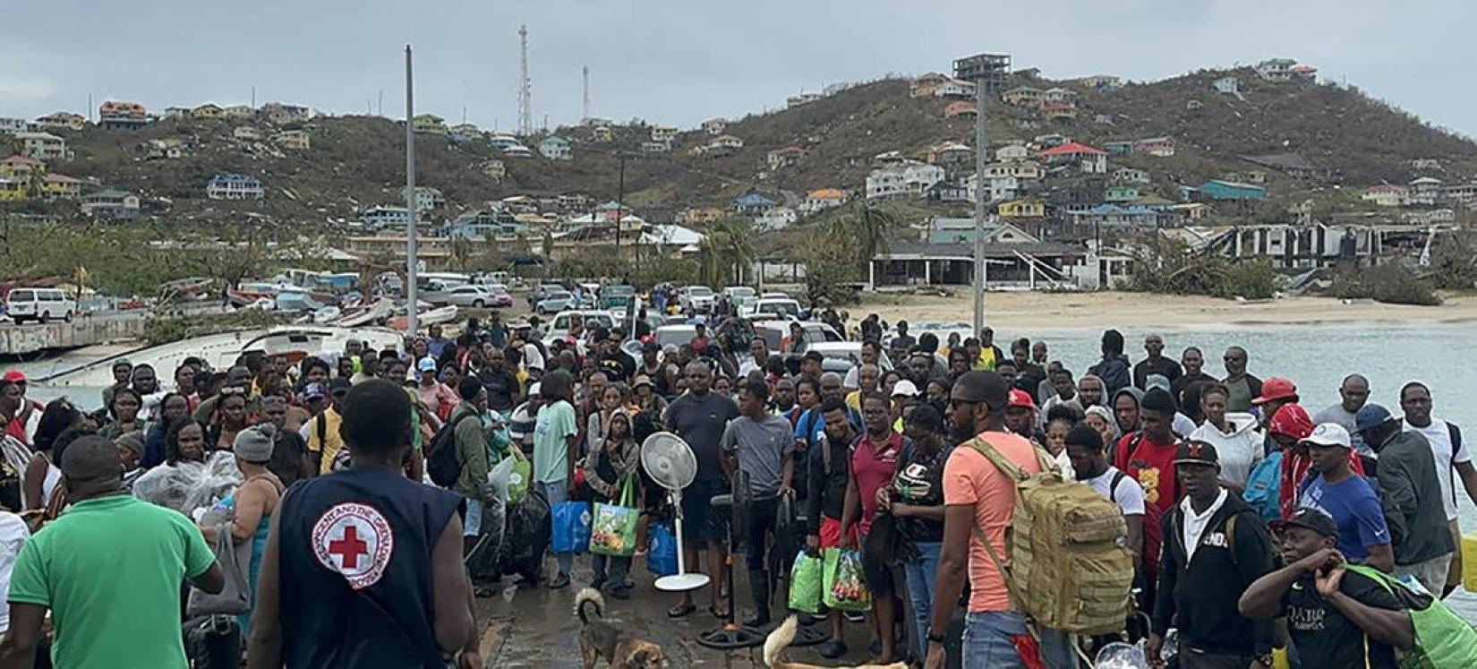 Residents of Union Island in Saint Vincent and the Grenadines prepare to board a ferry to reach shelter in the wake of Hurricane Beryl 