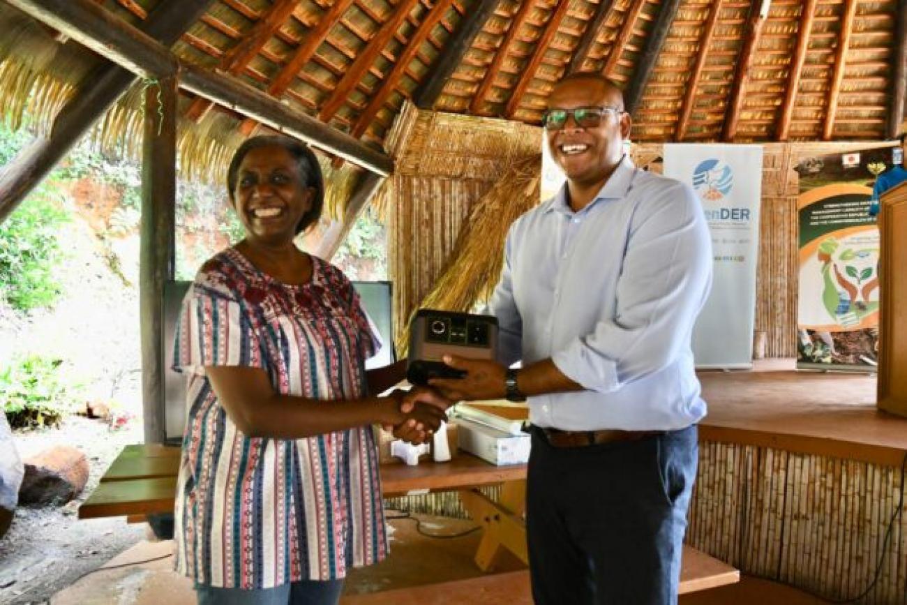 UNDP Resident Representative for Barbados and the Eastern Caribbean Limya Eltayeb presenting equipment to the Honourable Cozier Frederick Minister of the Environment, Rural Modernisation, Kalinago Upliftment and Constituency Empowerment. 