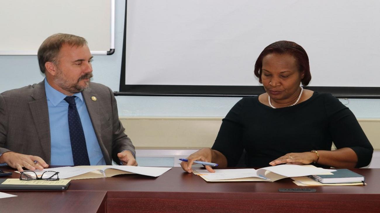 Representative and Country Director at the WFP Multi-country Office in Barbados Regis Chapman (Left) and St. Lucian Permanent Secretary Velda Octave-Joseph (Right) signing the Technical Assistance Agreement. 
