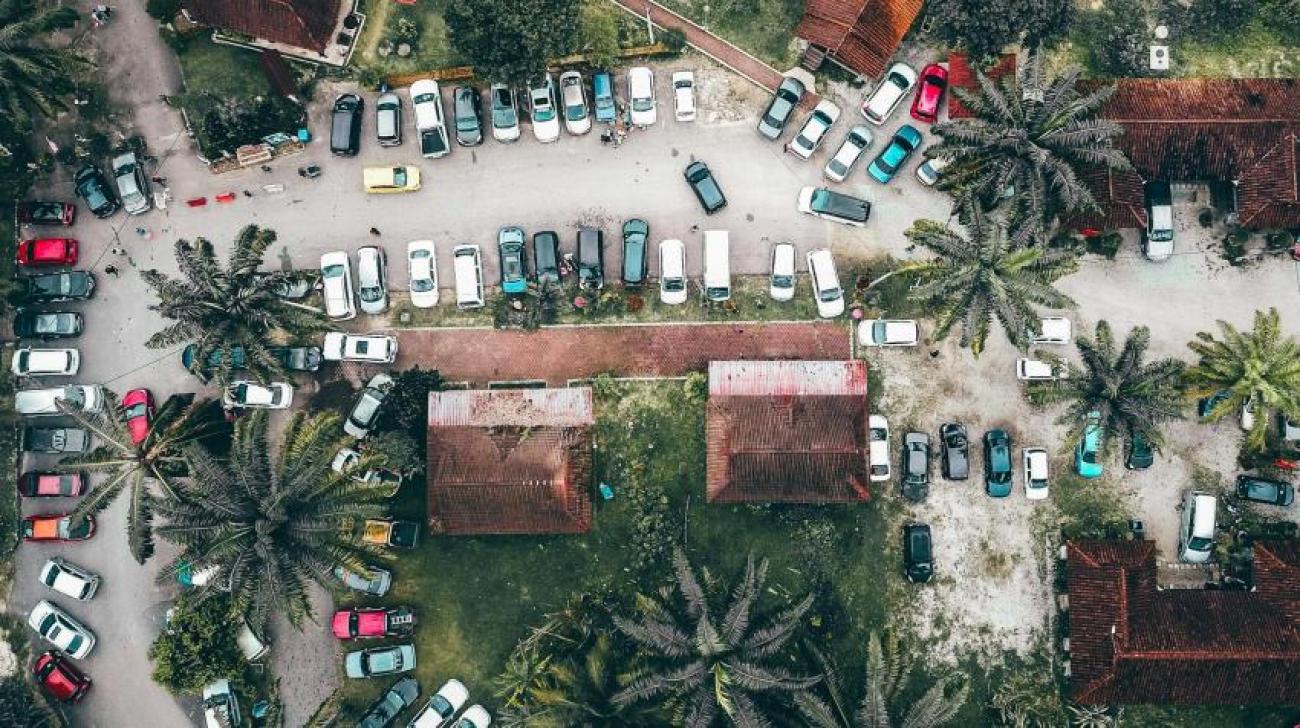 A parking lot with cars and trees