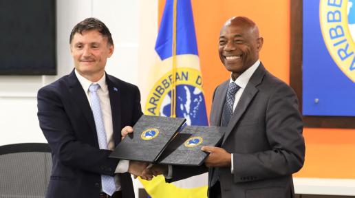 UN Resident Coordinator for Barbados and the Eastern Caribbean Didier Trebucq, and President of the Caribbean Development Bank Dr. Hyginus 'Gene' Leon exchanging signed Letters of Intent at the signing ceremony. 