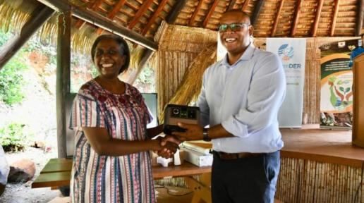 UNDP Resident Representative for Barbados and the Eastern Caribbean Limya Eltayeb presenting equipment to the Honourable Cozier Frederick Minister of the Environment, Rural Modernisation, Kalinago Upliftment and Constituency Empowerment. 