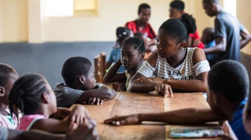 Group of children in a classroom sitting around a table