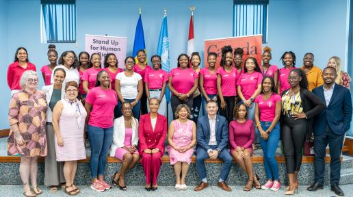 A group of young women from Pink Parliament Barbados pose with UN Resident Coordinator Didier Trebucq, High Commissioner of Canada H.E. Lilian Chatterjee, and other officials from the UN and the High Commission of Canada.