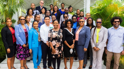 Staff of from the Saint Lucia Ministries of Health, Environment, and Sustainable Development attended the Green Climate Fund workshop standing on stairs and smiling
