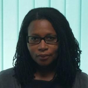 portrait of woman in glasses and sister locs