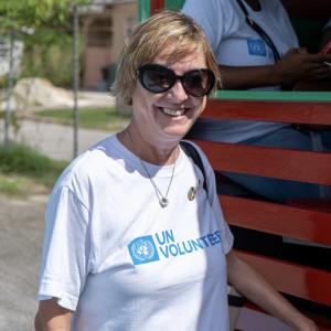portrait of woman in sunglasses and UN Volunteers t shirt